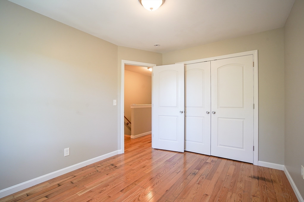 18-20 Healey Street, Unit 20 Springfield, MA 01151 - Photo 10 of 14 a view of an empty room and wooden floor