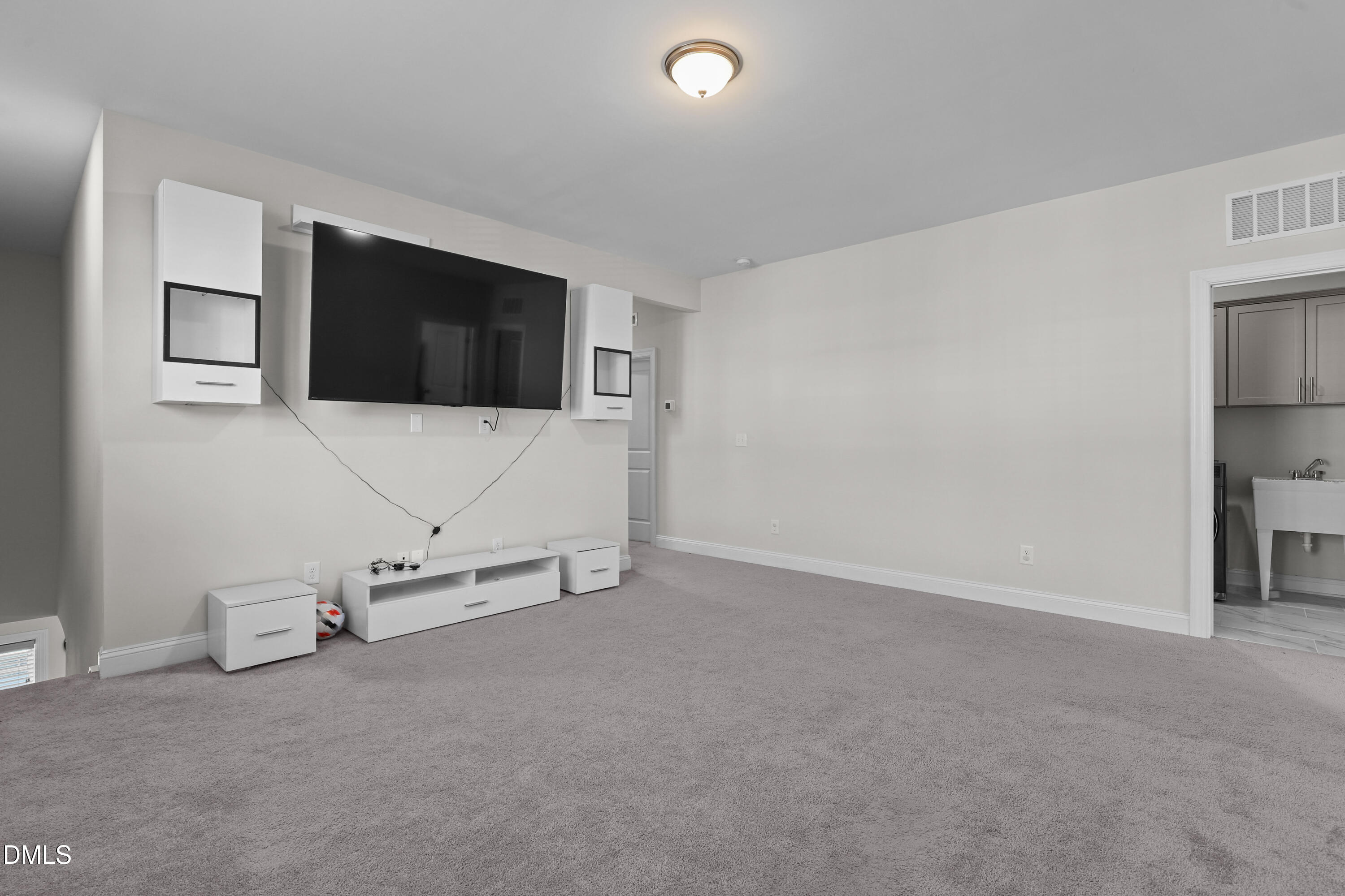 6117 Balance Court Raleigh, NC 27616 - Photo 21 of 44 a living room with furniture and a flat screen tv