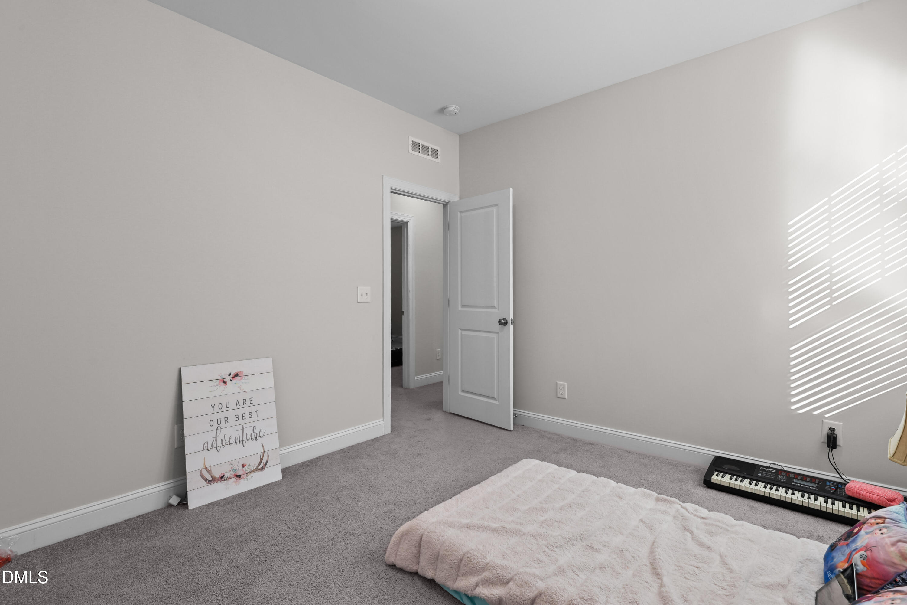 6117 Balance Court Raleigh, NC 27616 - Photo 33 of 44 a bedroom with a bed and a window