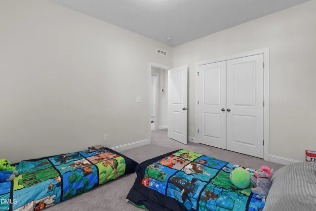 a bedroom with a bed and a dresser in it