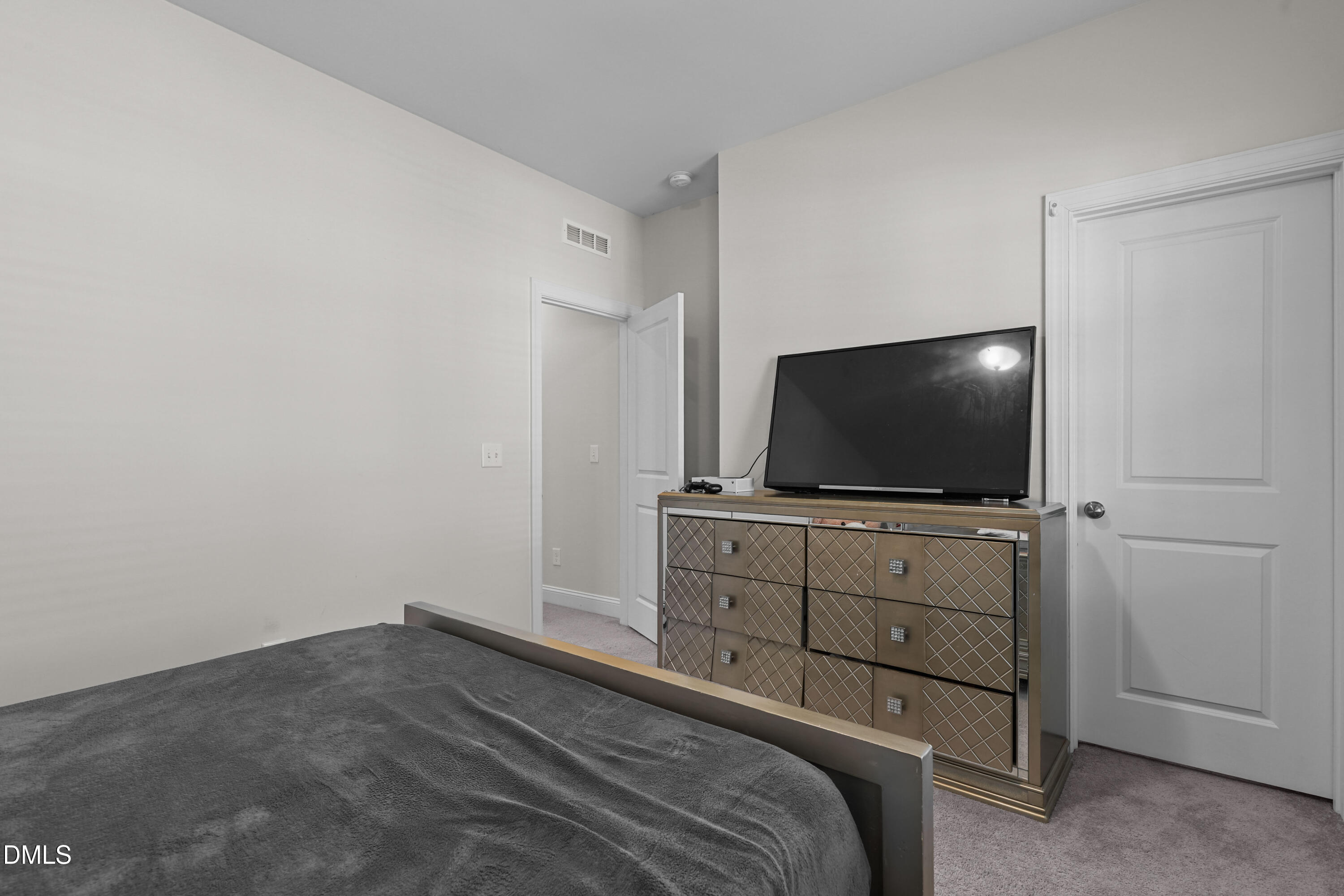 6117 Balance Court Raleigh, NC 27616 - Photo 37 of 44 a bedroom with a bed and a flat screen tv