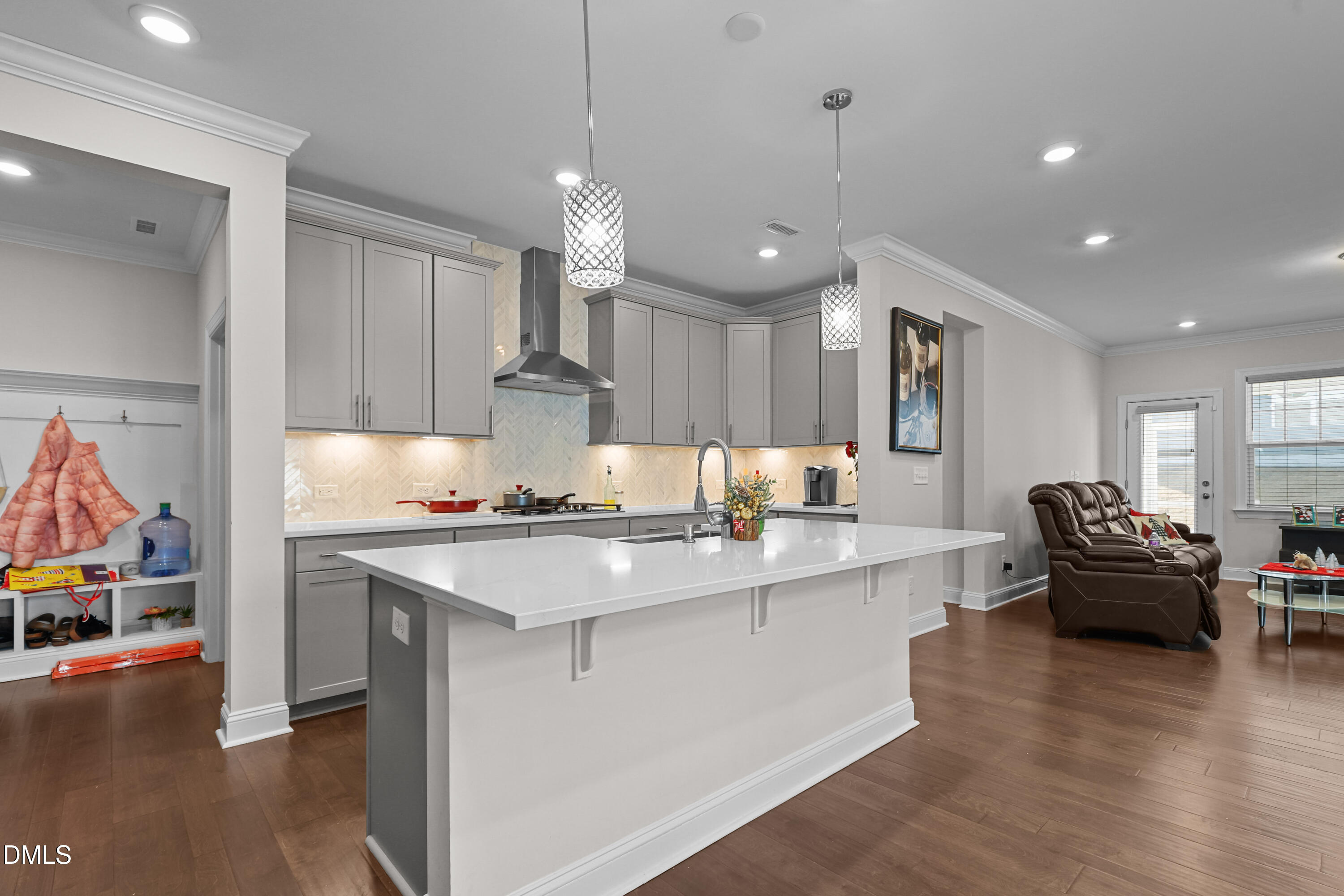 6117 Balance Court Raleigh, NC 27616 - Photo 4 of 44 a kitchen with kitchen island a stove and a wooden floors