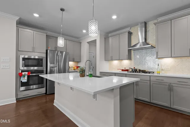 a kitchen with kitchen island a sink stove and cabinets