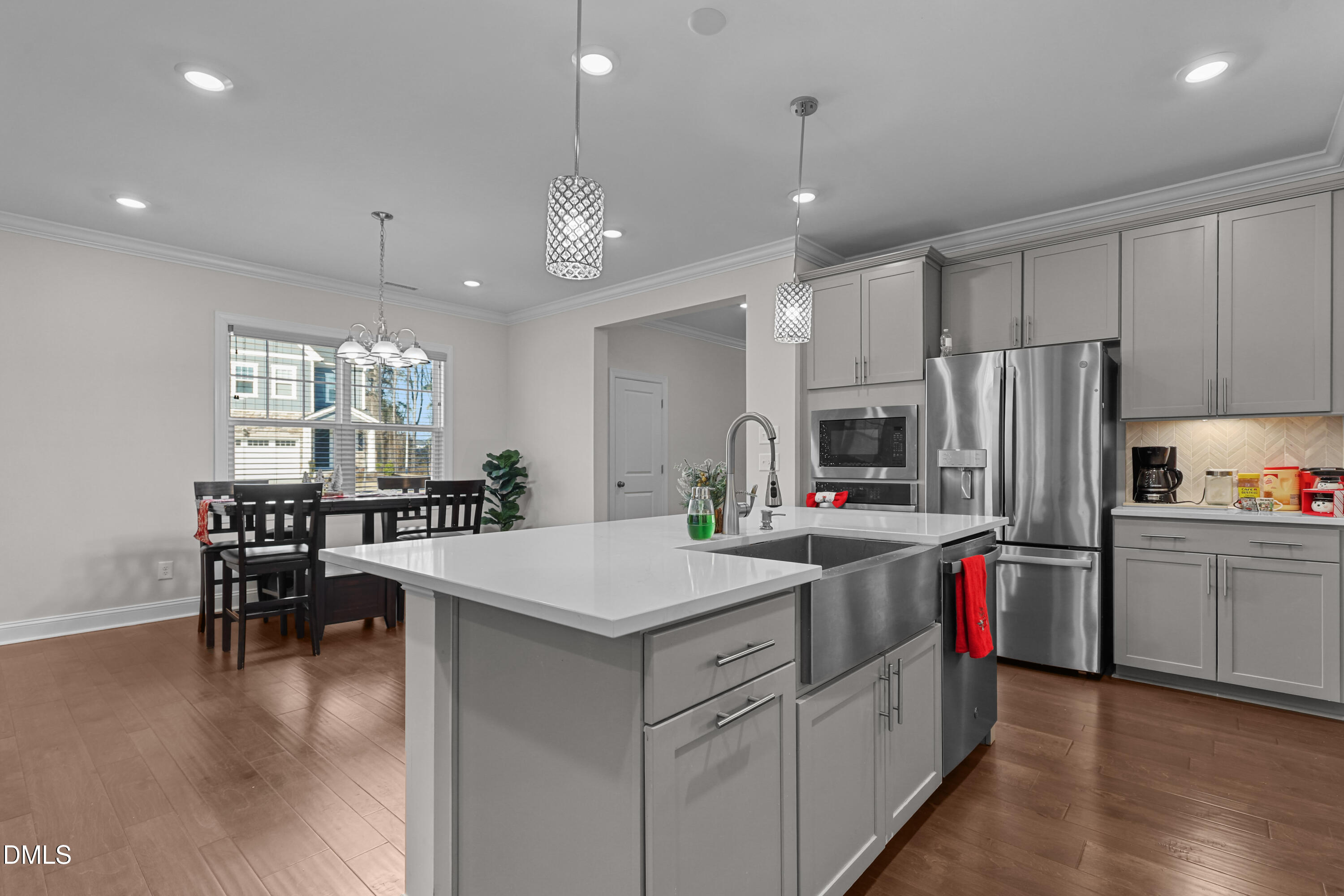 6117 Balance Court Raleigh, NC 27616 - Photo 7 of 44 a kitchen that has a lot of cabinets a sink and a refrigerator