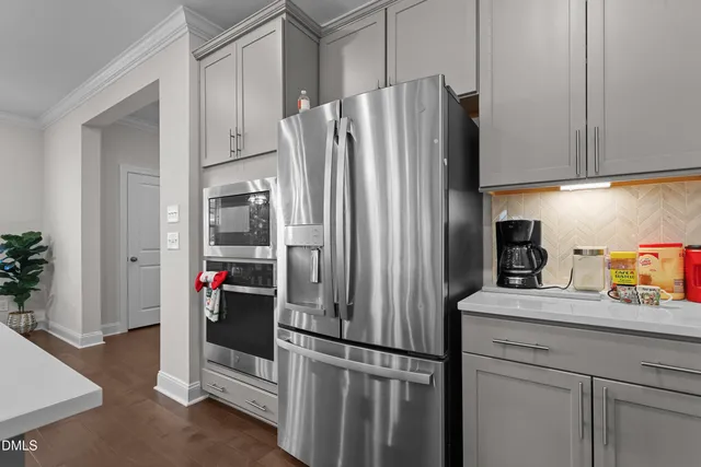 a kitchen with stainless steel appliances granite countertop a refrigerator and a sink