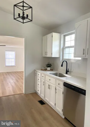 a kitchen with stainless steel appliances a refrigerator sink and cabinets