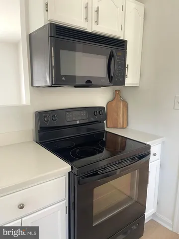 a view of a room with wooden floor and a window