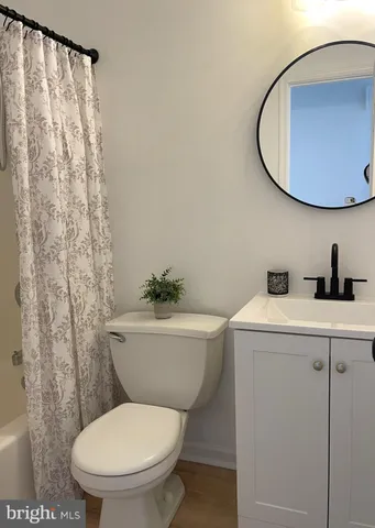 a bathroom with a toilet a sink and bathtub