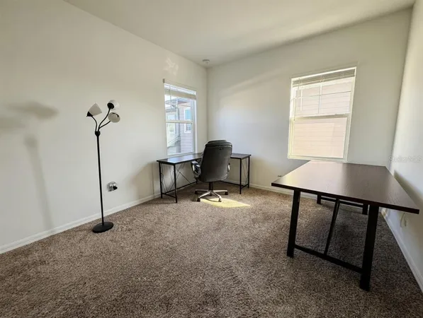 a workspace with furniture and window