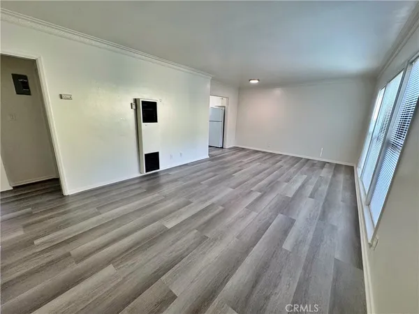 a view of empty room with wooden floor