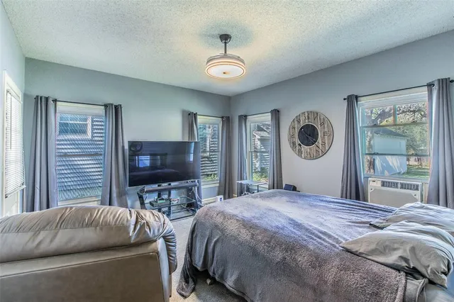 a bedroom with a bed dresser and a window