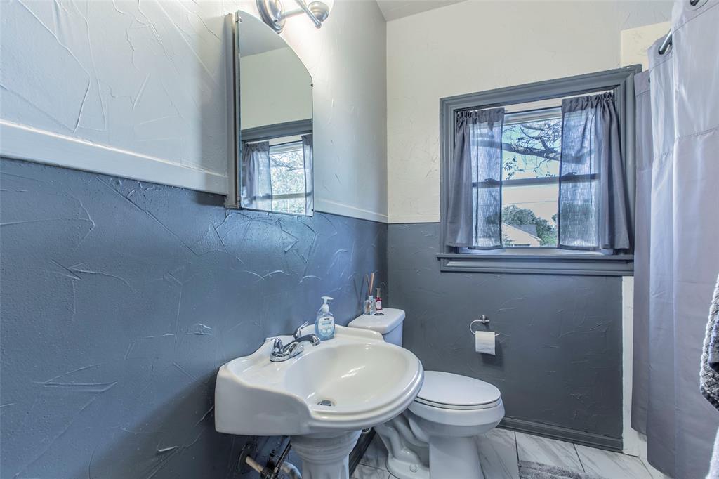 2603 Pine Avenue Waco, TX 76708 - Photo 14 of 23 a bathroom with a toilet sink and mirror