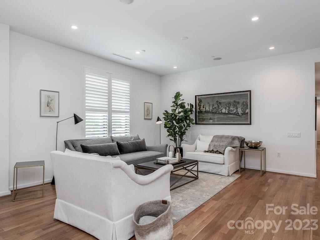 1333 Queens Road, Unit E1 Charlotte, NC 28207 - Photo 11 of 19 a living room with furniture and a large window
