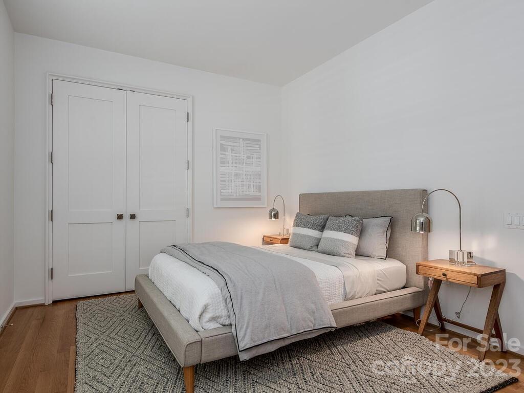 1333 Queens Road, Unit E1 Charlotte, NC 28207 - Photo 15 of 19 a bedroom with a bed and a chair