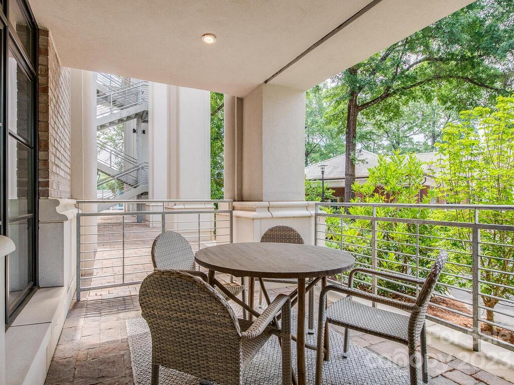 1333 Queens Road, Unit E1 Charlotte, NC 28207 - Photo 18 of 19 a view of a dining room with furniture window and outside view