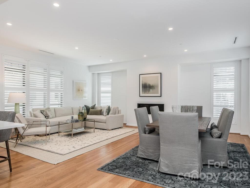 1333 Queens Road, Unit E1 Charlotte, NC 28207 - Photo 4 of 19 a living room with furniture large window and wooden floor