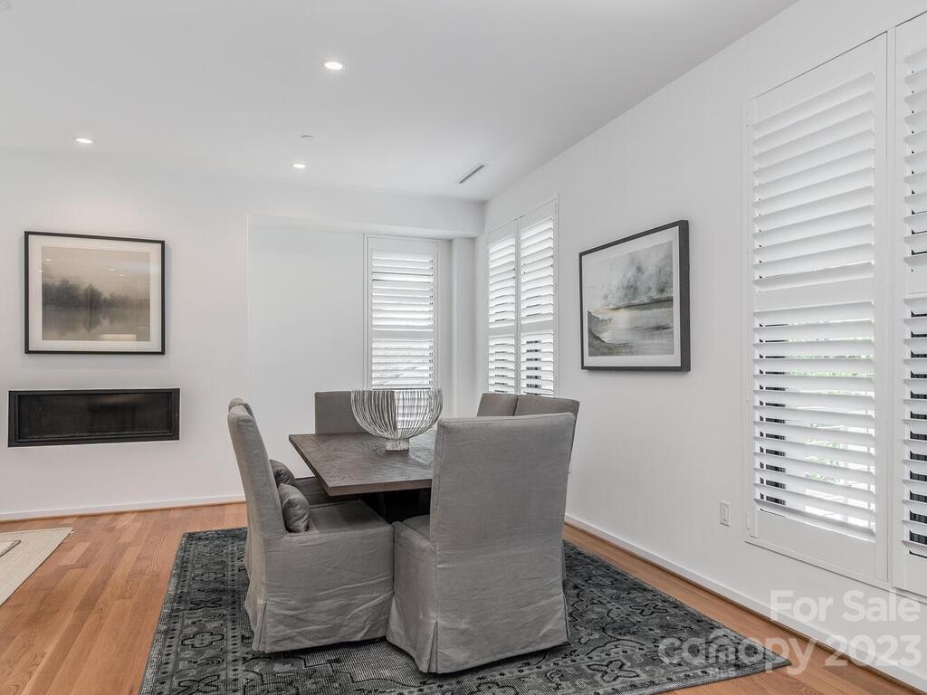 1333 Queens Road, Unit E1 Charlotte, NC 28207 - Photo 5 of 19 a dining room with furniture and window