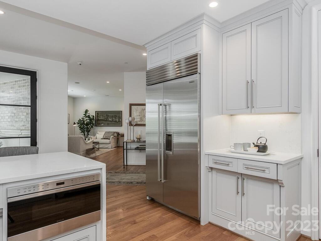 1333 Queens Road, Unit E1 Charlotte, NC 28207 - Photo 9 of 19 a kitchen with a sink stainless steel appliances and cabinets