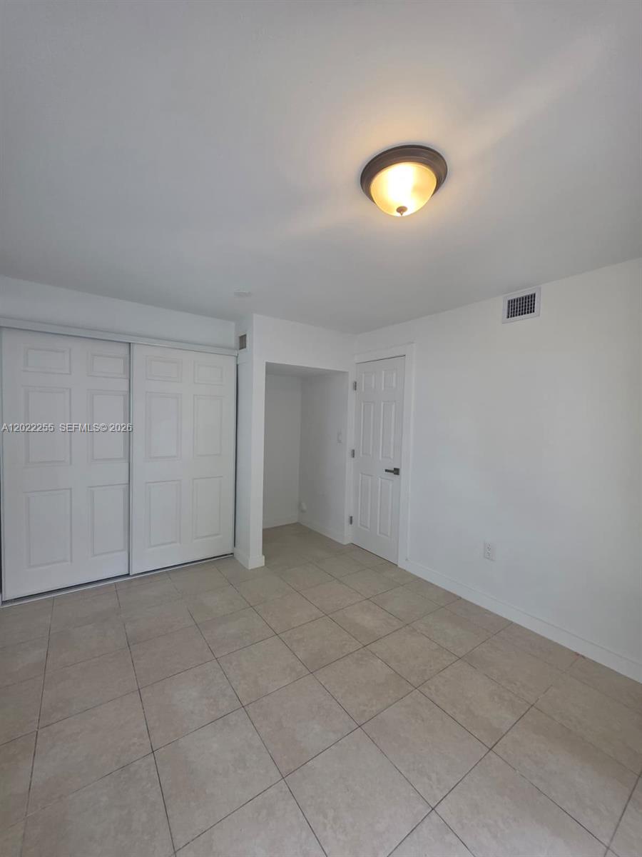 829 Southwest 3rd Street, Unit 831 Miami, FL 33130 - Photo 19 of 21 an empty room with a fan & a window