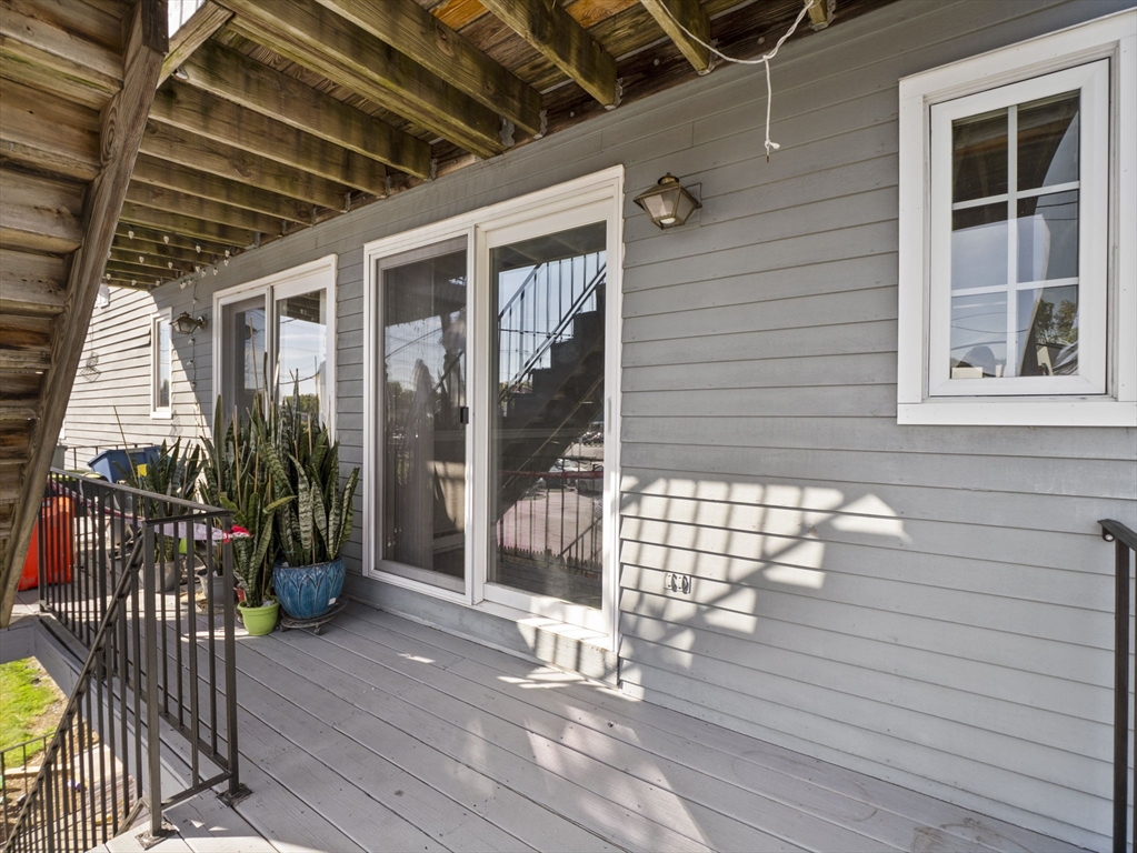 1821 Middlesex Street, Unit 10 Lowell, MA 01851 - Photo 21 of 26 a view of porch with wooden stairs