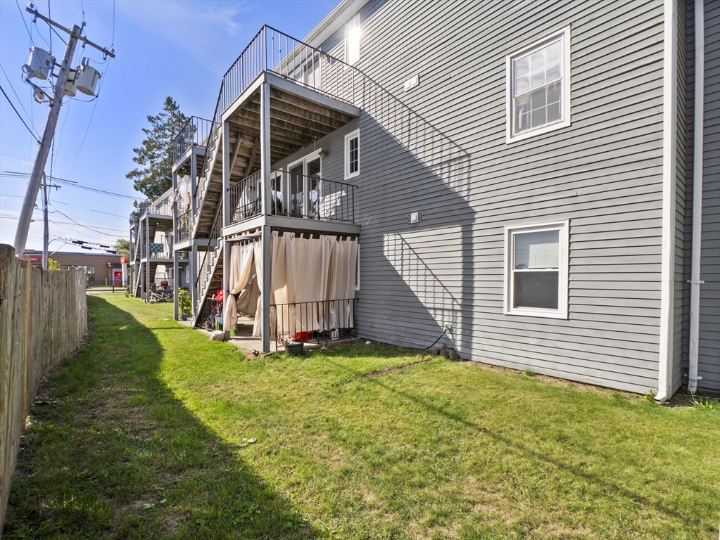 1821 Middlesex Street, Unit 10 Lowell, MA 01851 - Photo 23 of 26 a view of a house with a yard