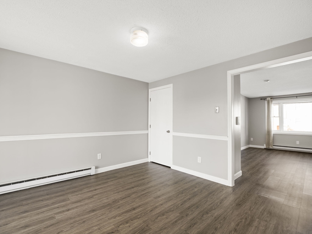 1821 Middlesex Street, Unit 10 Lowell, MA 01851 - Photo 5 of 26 wooden floor in an empty room