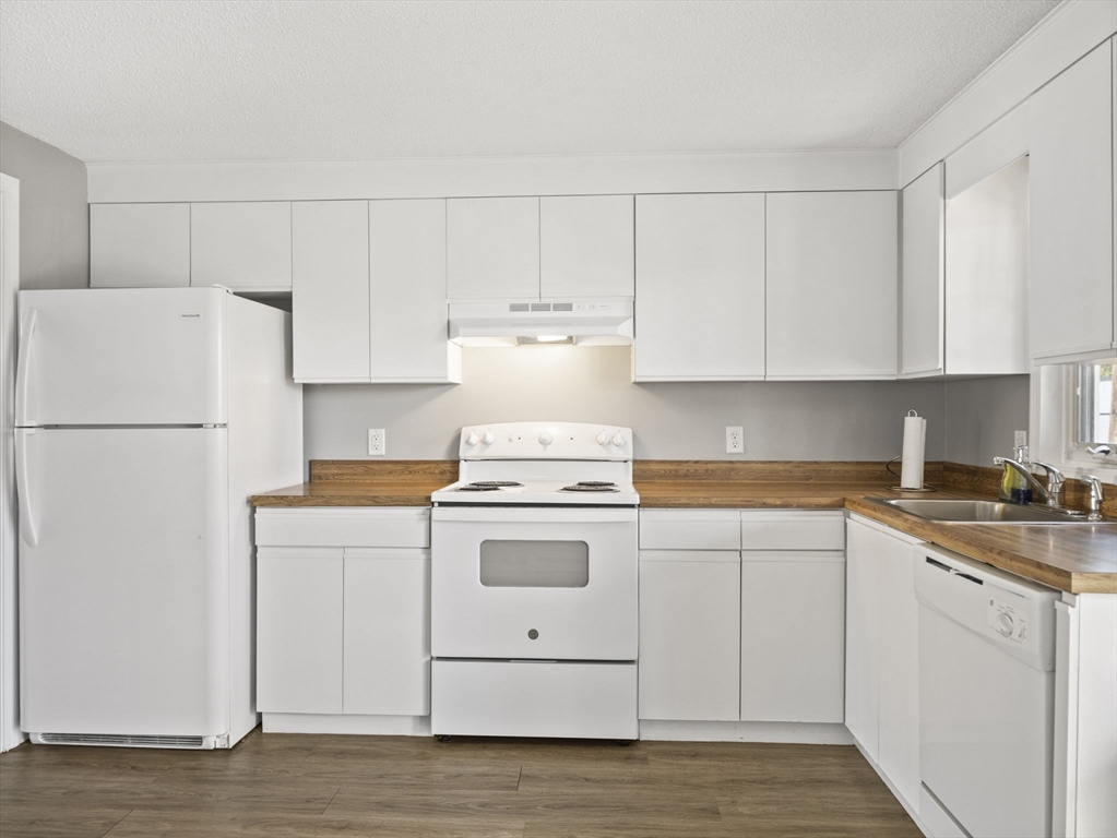 1821 Middlesex Street, Unit 10 Lowell, MA 01851 - Photo 6 of 26 a kitchen with cabinets appliances a sink and a stove