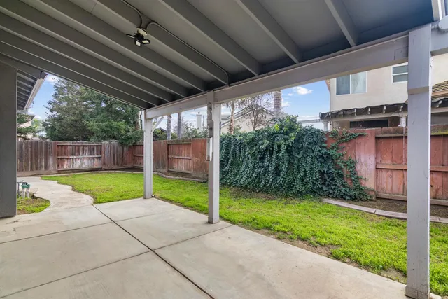 a view of a porch with furniture and a yard