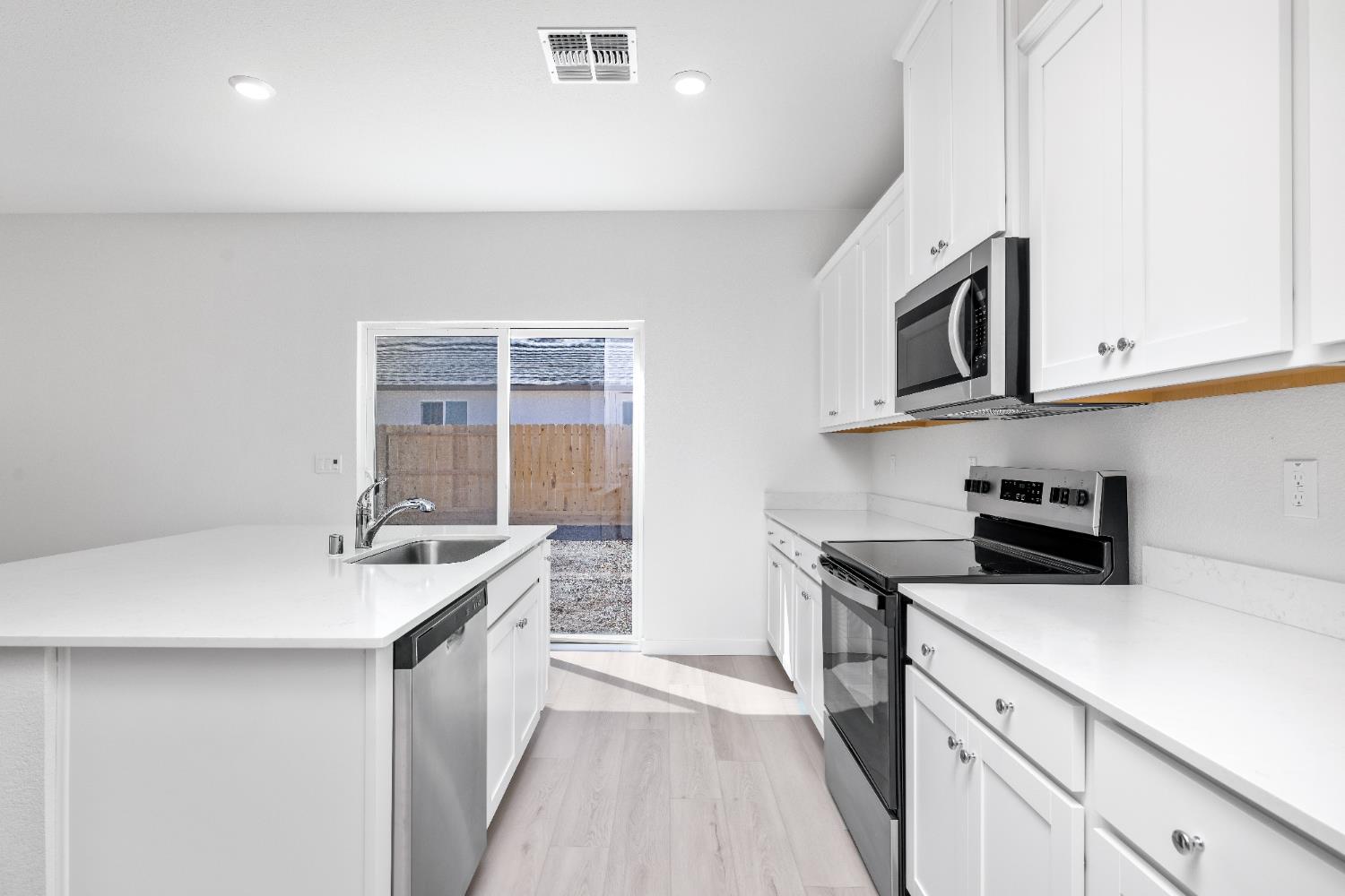 929 South Mylea Court Stockton, CA 95215 - Photo 8 of 8 a kitchen with a sink stove and microwave