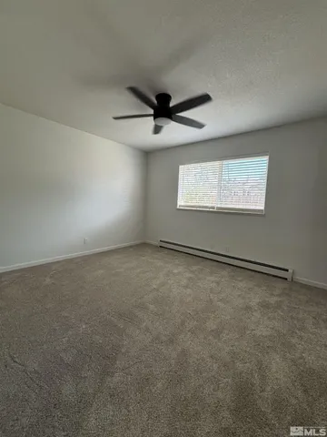 an empty room with a empty space and a ceiling fan