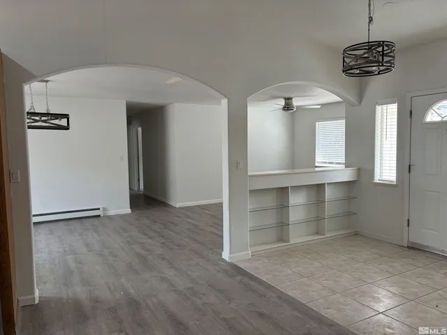 an empty room with closet and windows