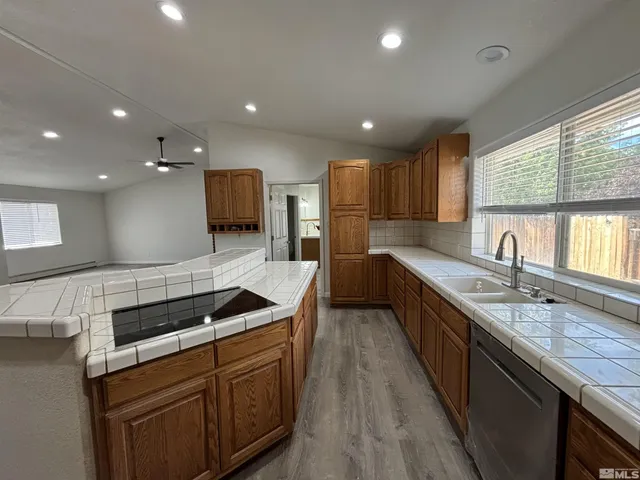 a kitchen with granite countertop a sink and cabinets