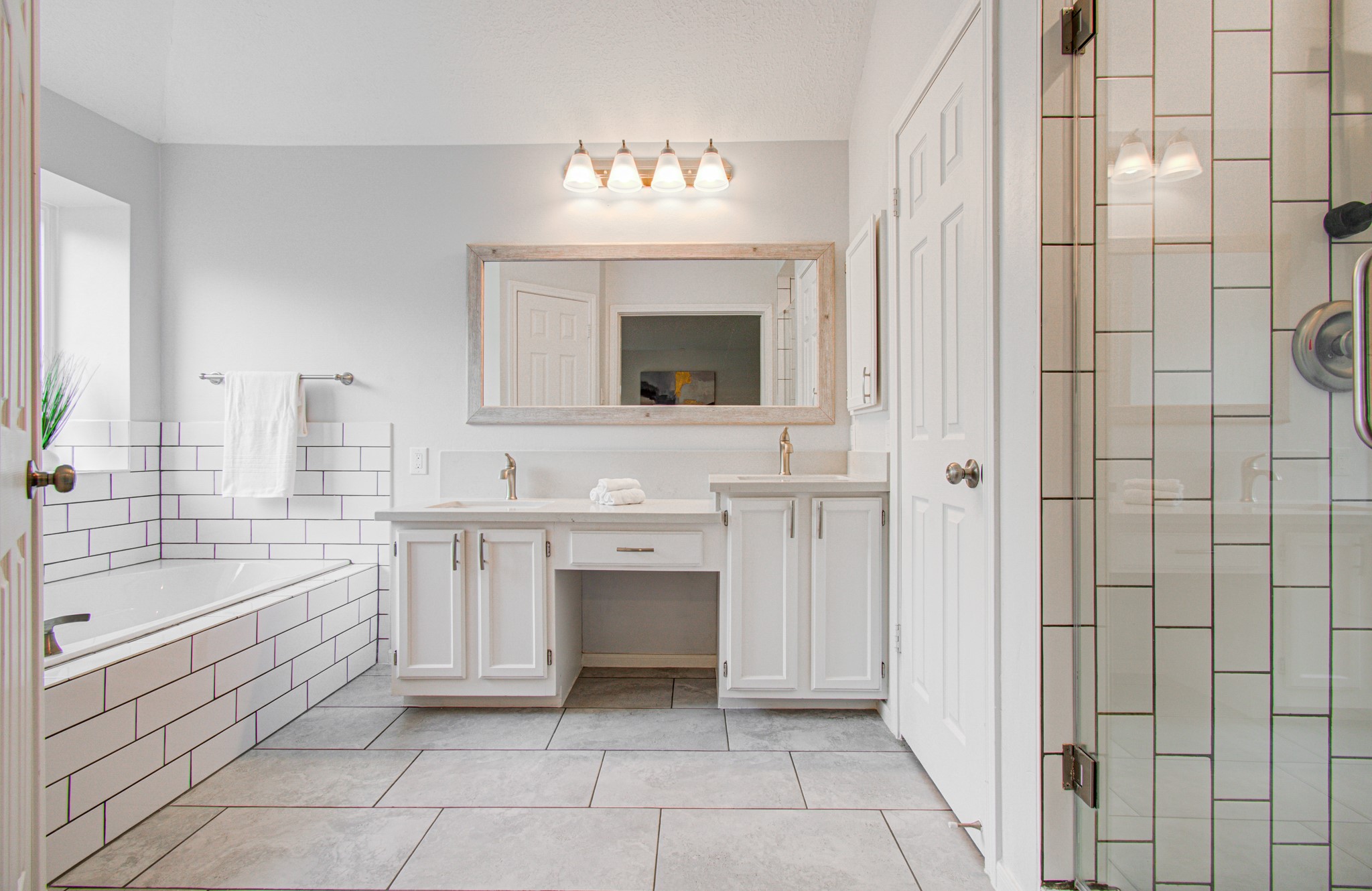 22927 Northoak Forest Lane Spring, TX 77389 - Photo 17 of 37 a bathroom with a sink a large mirror and a bathtub