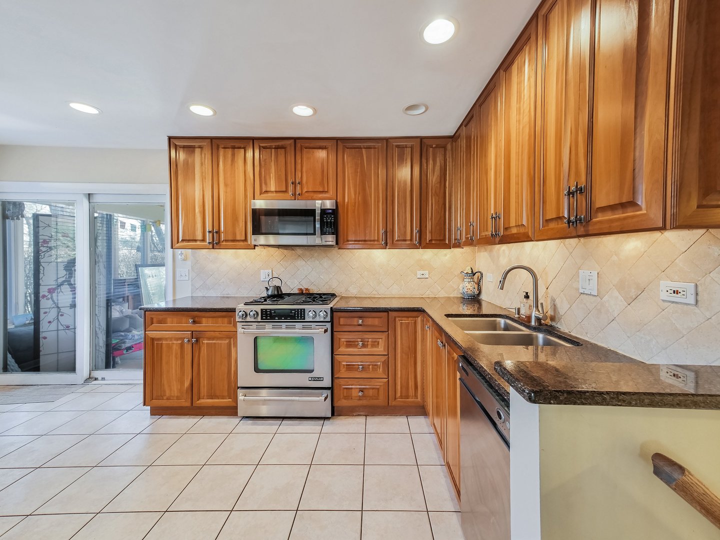 1903 Hopi Lane Mount Prospect, IL 60056 - Photo 6 of 36 a kitchen with stainless steel appliances granite countertop a stove a sink and a microwave