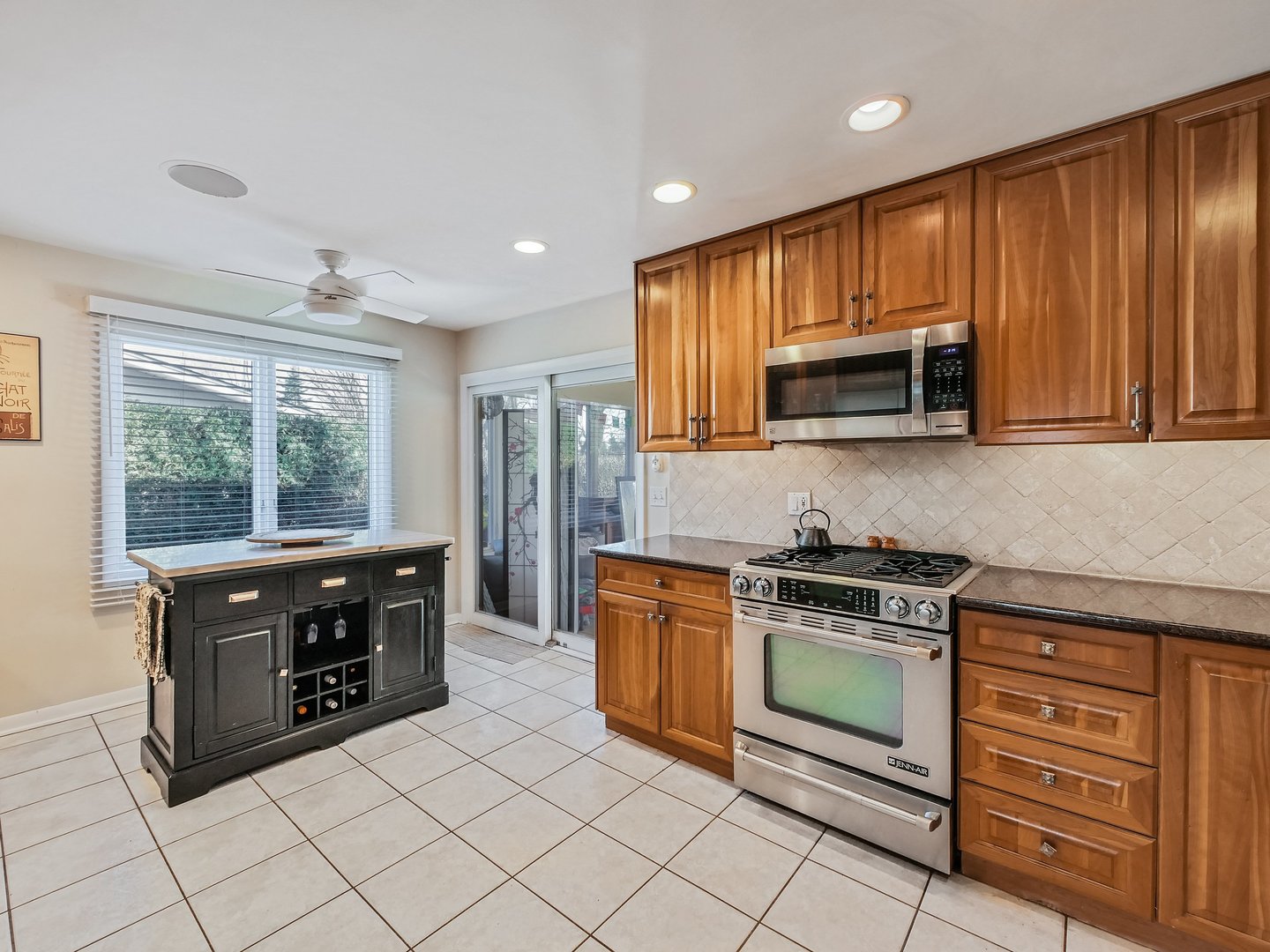 1903 Hopi Lane Mount Prospect, IL 60056 - Photo 7 of 36 a kitchen with stainless steel appliances granite countertop a stove a sink and a microwave