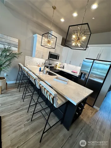 a view of a dining room with furniture wooden floor and chandelier