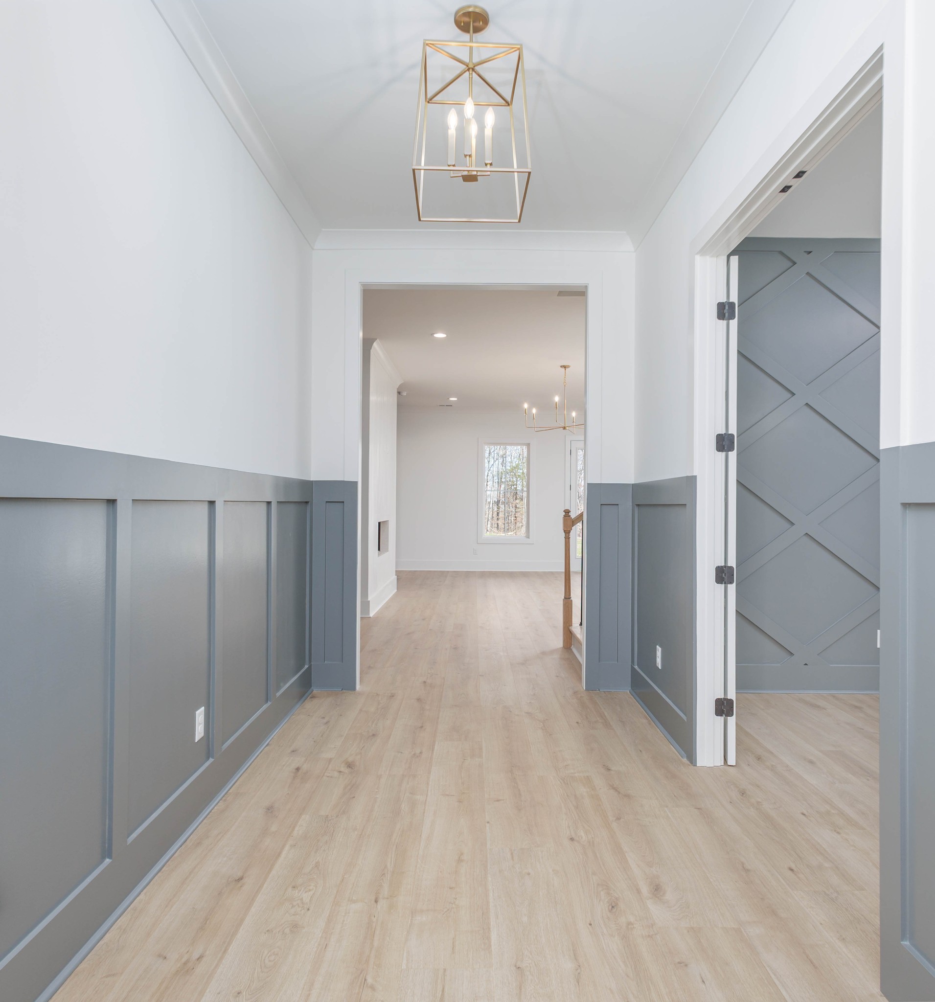 7771 Barnhill Road Primm Springs, TN 38476 - Photo 12 of 61 a view of a hallway with wooden floor and a chandelier