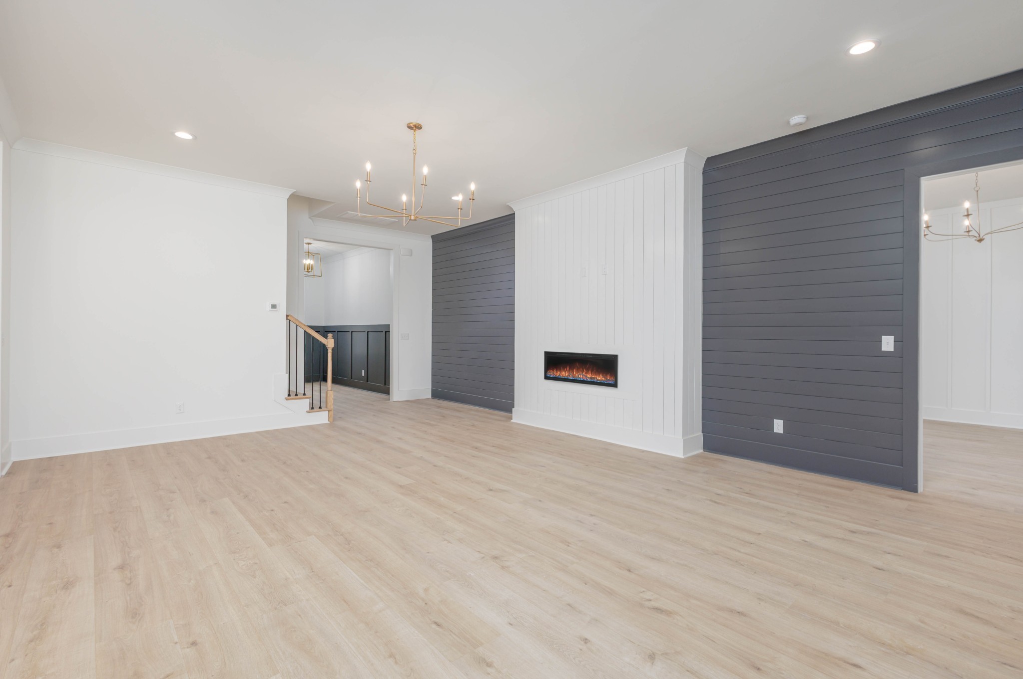7771 Barnhill Road Primm Springs, TN 38476 - Photo 25 of 61 a view of an empty room with wooden floor and kitchen