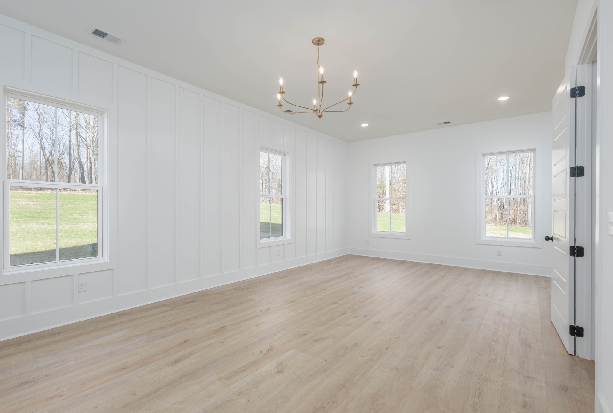 7771 Barnhill Road Primm Springs, TN 38476 - Photo 26 of 61 a view of an empty room with a window and wooden floor