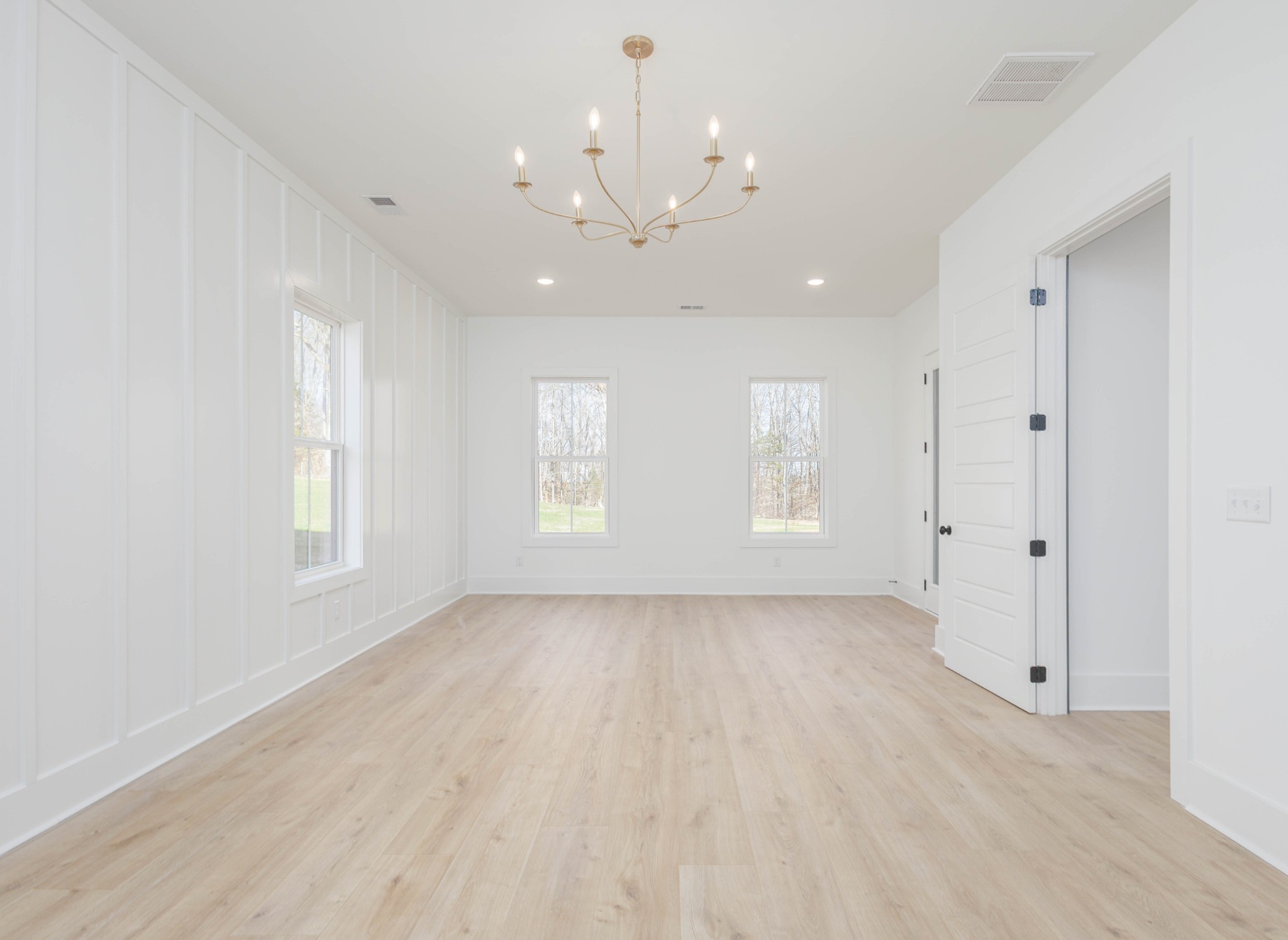 7771 Barnhill Road Primm Springs, TN 38476 - Photo 27 of 61 an empty room with chandelier fan and windows
