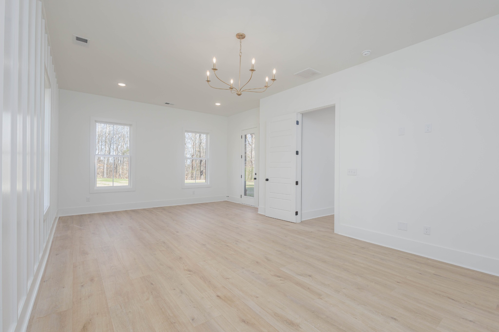 7771 Barnhill Road Primm Springs, TN 38476 - Photo 28 of 61 an empty room with chandelier fan and windows