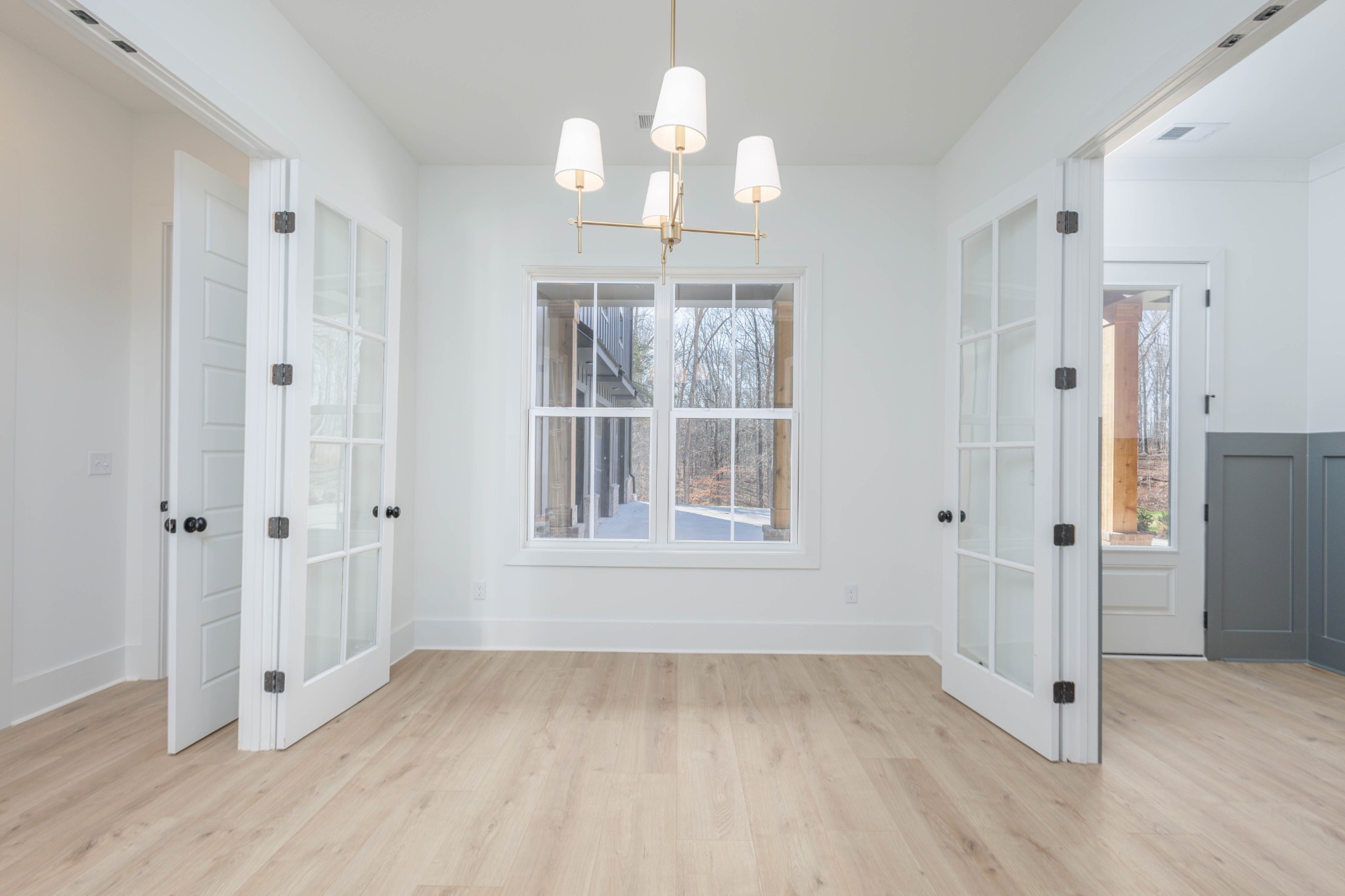 7771 Barnhill Road Primm Springs, TN 38476 - Photo 40 of 61 an empty room with wooden floor cabinet and windows