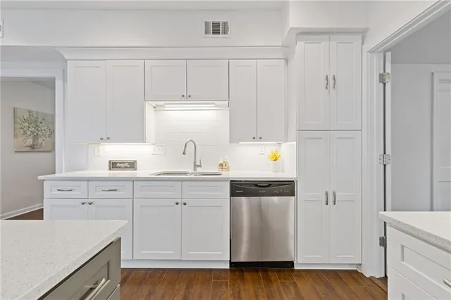a kitchen with white cabinets and white appliances