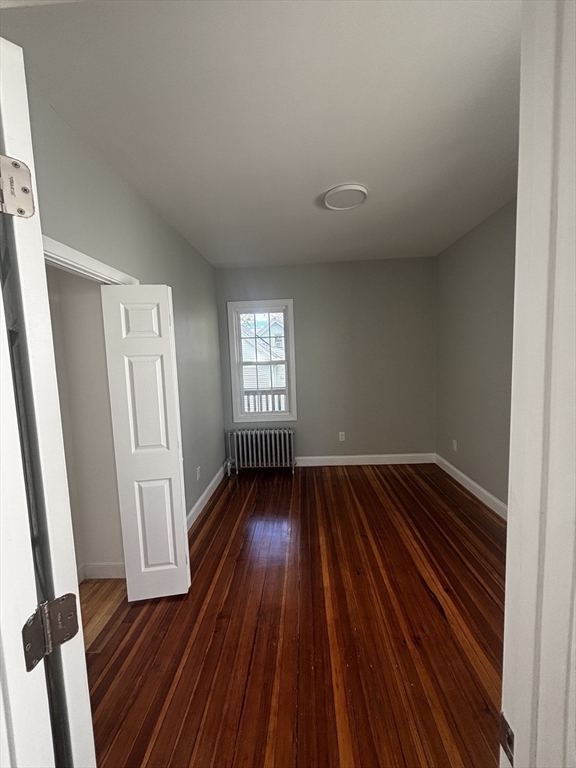 33 Wolcott Street, Unit 3 Boston, MA 02121 - Photo 8 of 8 a view of an empty room with wooden floor and a window