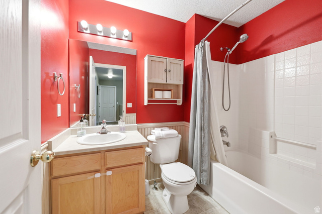 5485 Heather Way Tooele, UT 84074 - Photo 25 of 41 Full bathroom featuring a single vanity with wood-finish cabinetry, a white basin, and a wall-mounted mirror