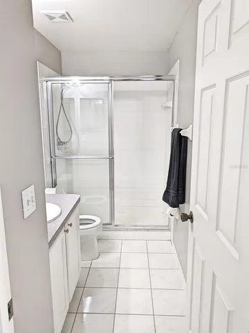 a bathroom with a shower a toilet and a sink