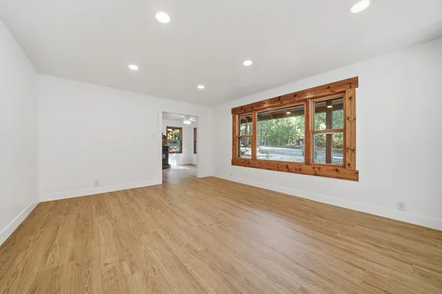 a big room with wooden floor and windows