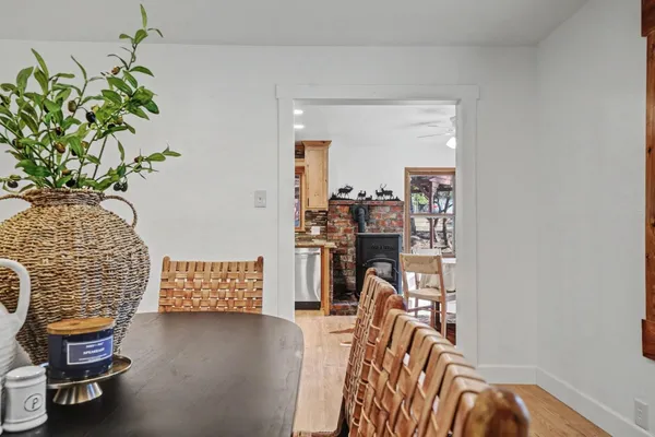 a kitchen with stainless steel appliances granite countertop a refrigerator stove and wooden floor