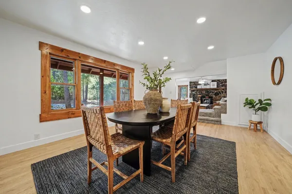 a bathroom with a granite countertop sink a large mirror and a bathtub