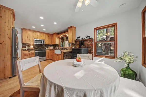 a view of a hallway with wooden floor and a bathroom